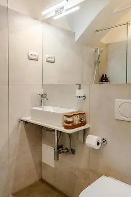 a bathroom with a sink and a mirror at Sofija's Central Apartments in Ljubljana