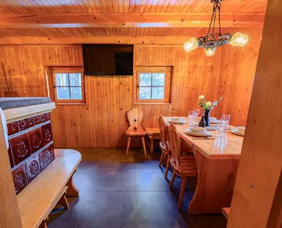 a dining room with a long wooden table and chairs at Relax house AVUS with Sauna in Slappe dʼIdria