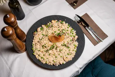 a plate of rice and a butterfly on a table at B&B Mio Nonno Rooms Ljubljana in Ljubljana