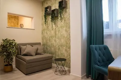 a living room with a couch and two blue chairs at B&B Mio Nonno Rooms Ljubljana in Ljubljana