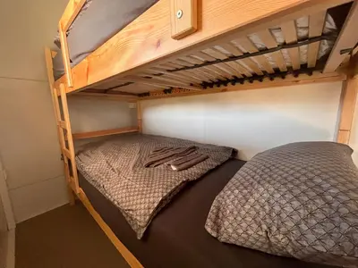 a bunk bed in a small room with a bunk bedutenewayangering at Mobilna hiška Sončni Gaj in Ptuj