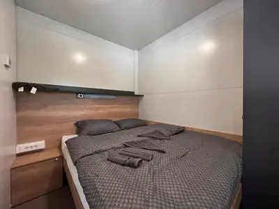 a bedroom with a large bed in a room at Mobilna hiška Sončni Gaj in Ptuj