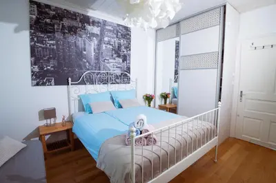 a bedroom with a bed with a teddy bear on it at Riverview Residence - with parking in Ljubljana