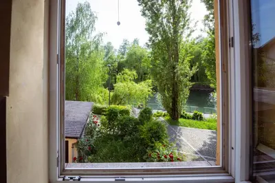 a window with a view of a garden at Riverview Residence - with parking in Ljubljana