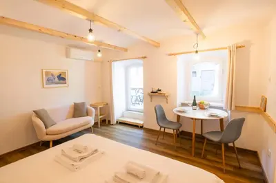 a living room with a table and chairs and a couch at Jerry's Old Town Garden in Ljubljana