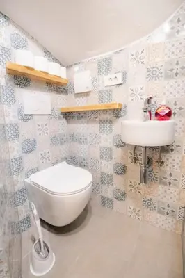 a bathroom with a toilet and a sink at Jerry's Old Town Garden in Ljubljana