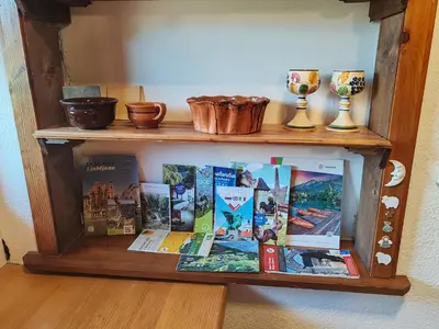 a wooden shelf with books and vases on it at Apartment Ursa Major in Preddvor