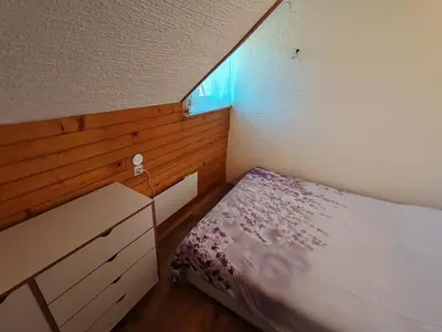 a small bedroom with a bed and a dresser at Apartment Ursa Major in Preddvor