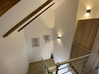 a staircase in a house with two lights on the wall at Apartmaji Sofija&Ana in Bovec