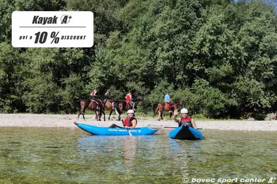 a group of people are in kayaks in the water at Glamping Virje in Bovec