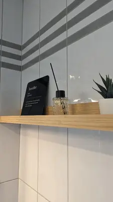 a wooden shelf with a book and a candle on it at Nono Apartment in Renče