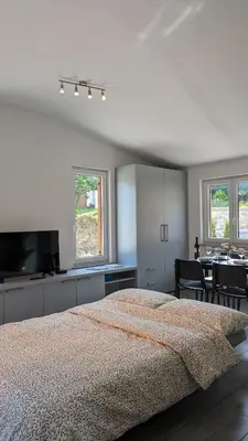 a bedroom with a bed and a table and chairs at Nono Apartment in Renče