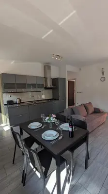 a living room with a table and a couch at Nono Apartment in Renče