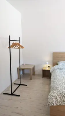 a bedroom with a bed and a table in a room at Nono Apartment in Renče