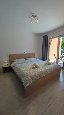 a bedroom with a bed with two towels on it at Nono Apartment in Renče
