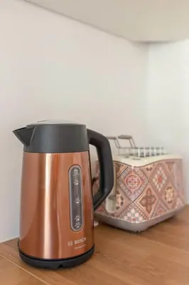 a coffee pot sitting on a table next to a toaster at DSE Apartment in Celje