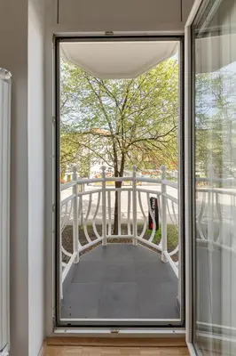 a window view of a balcony with a tree at DSE Apartment in Celje
