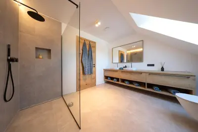 a bathroom with a glass shower and a sink at House Natura Savica in Bohinj