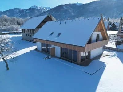 an aerial view of a house in the snow at House Natura Savica in Bohinj