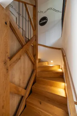 a staircase in a house with wooden floors at House Natura Savica in Bohinj