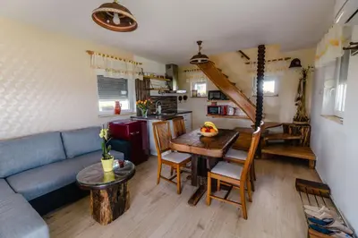 a living room with a blue couch and a table at WeinSpitz - Wellness House in Miklavž pri Ormožu