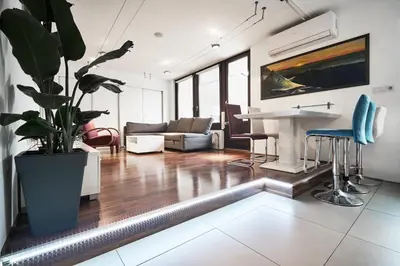 a living room with a couch and a table at Matic Murgle Atrium Apartment in Ljubljana