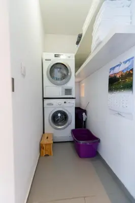 a laundry room with a washer and a washing machine at Matic Murgle Atrium Apartment in Ljubljana