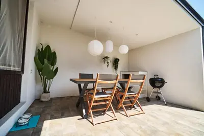a dining room with a table and chairs at Matic Murgle Atrium Apartment in Ljubljana