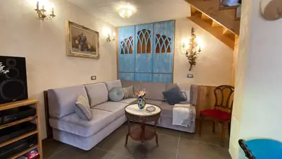 a living room with a couch and a table at Krasna Hiška - Authentic Heritage Home in Sežana