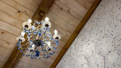 a chandelier hanging from a ceiling in a room at Krasna Hiška - Authentic Heritage Home in Sežana