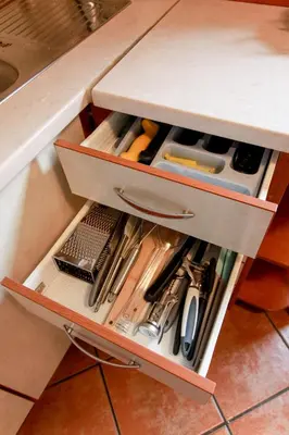 a drawer filled with tools in a kitchen counter at Apartma Dvor Milena in Bovec