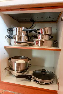 a shelf with pots and pans in a kitchen at Apartma Dvor Milena in Bovec