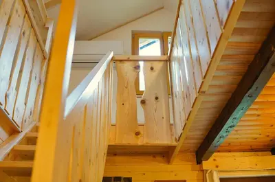 a staircase in a house with wooden beams at Zeleni raj Green Paradise House in Žužemberk