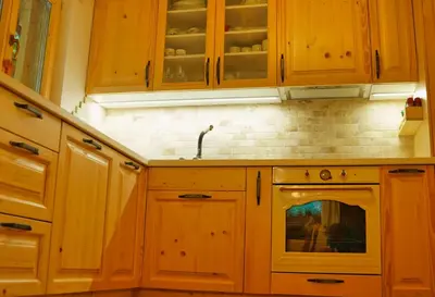 a kitchen with wooden cabinets and a stove top oven at Zeleni raj Green Paradise House in Žužemberk
