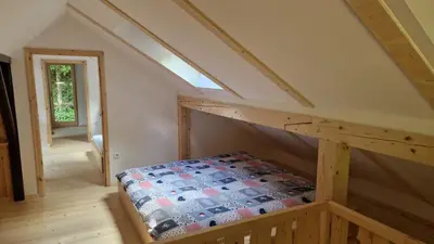 a room with a bed in the attic at Zeleni raj Green Paradise House in Žužemberk