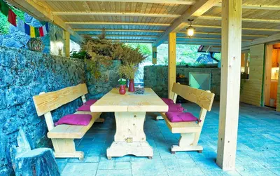 a wooden table and benches on a patio at Zeleni raj Green Paradise House in Žužemberk