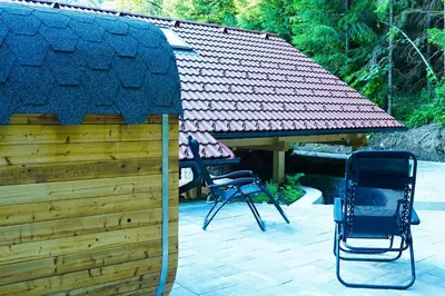 two chairs and a gazebo in a yard at Zeleni raj Green Paradise House in Žužemberk