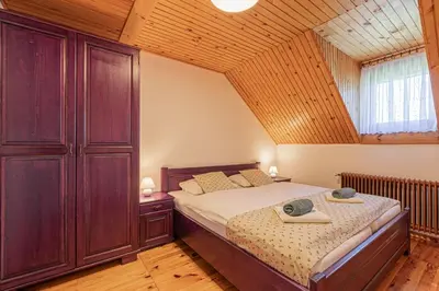 a bedroom with a bed and a wooden ceiling at Organic Homestead Mikl in Slovenj Gradec