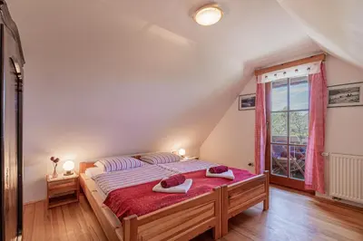 a bedroom with a bed with two towels on it at Organic Homestead Mikl in Slovenj Gradec