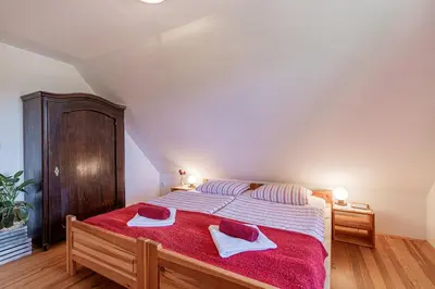 a bedroom with a bed with two towels on it at Organic Homestead Mikl in Slovenj Gradec