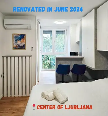 a room with a bed and two blue chairs at TOP - Ljubljana's Central Gem - free public parking in Ljubljana
