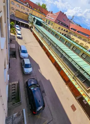 a group of cars parked next to a train station at TOP - Ljubljana's Central Gem - free public parking in Ljubljana