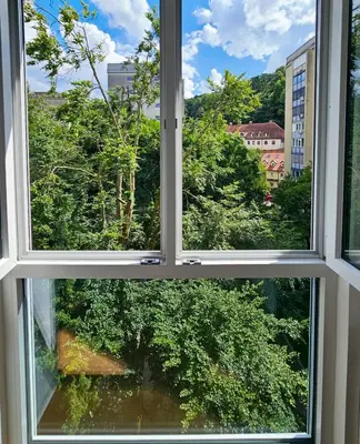an open window with a view of a garden at TOP - Ljubljana's Central Gem - free public parking in Ljubljana