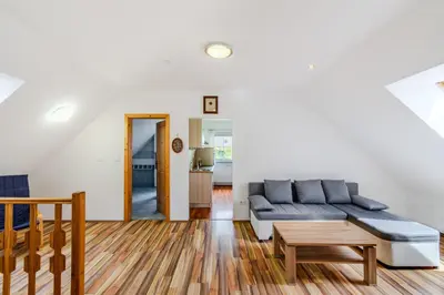 a living room with a couch and a table at Apartment Pr' Štajercu with Free Onsite Parking in Bovec