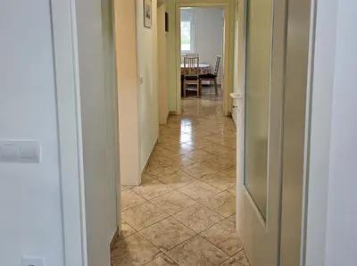a hallway with a tile floor in a house at Hišica ob Potoku in Podčetrtek