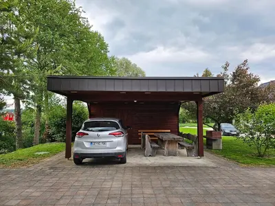 a car parked in front of a shed at Hišica ob Potoku in Podčetrtek