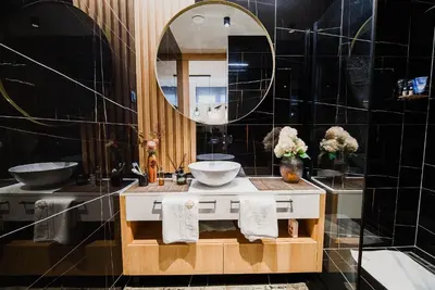 a bathroom with a sink and a mirror at Apartments Slavec with Free Onsite Parking in Kranjska Gora