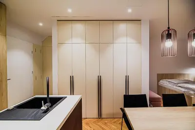 a kitchen with a sink and a refrigerator at Apartments Slavec with Free Onsite Parking in Kranjska Gora