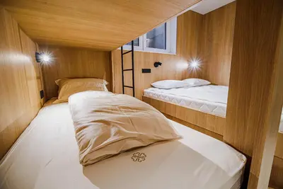 a small bedroom with two beds in a boat at Apartments Slavec with Free Onsite Parking in Kranjska Gora