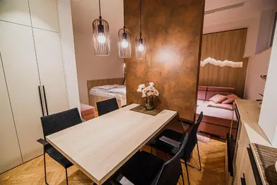 a dining room with a wooden table and chairs at Apartments Slavec with Free Onsite Parking in Kranjska Gora
